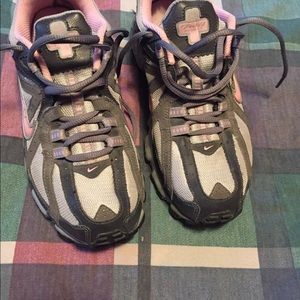 One pair of Woman’s Nike Trail Running shoes.